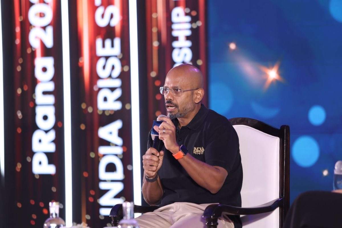 A speaker in conversation at PRana 2025